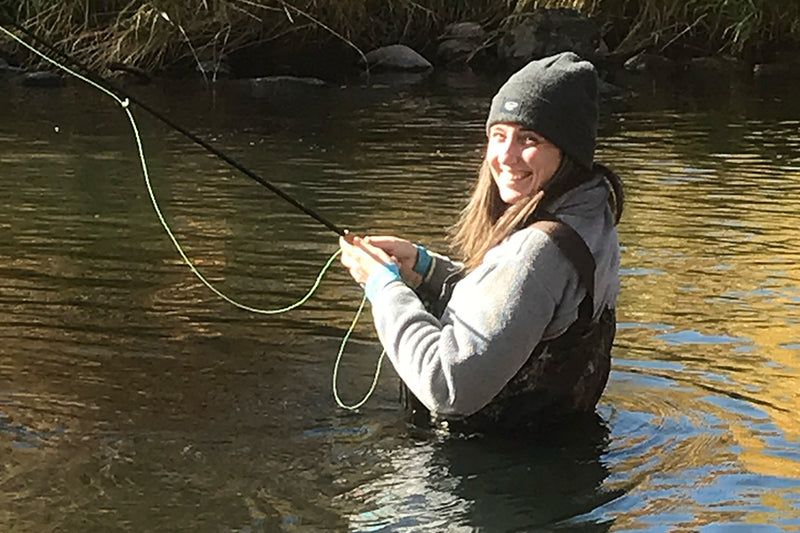 Woman fishing with a big smile. 