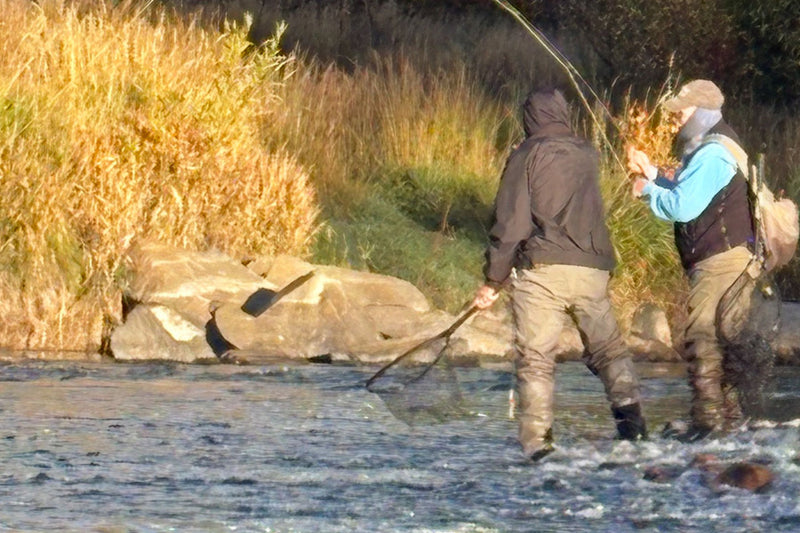 Scenic river with two fly fishermen. 